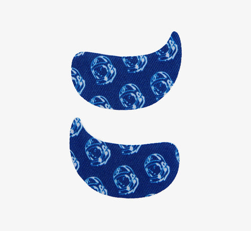 Brightening undereye patches from Topicals in a blue astronaut-print hydrogel design, shown as a left and right pair on a white background.